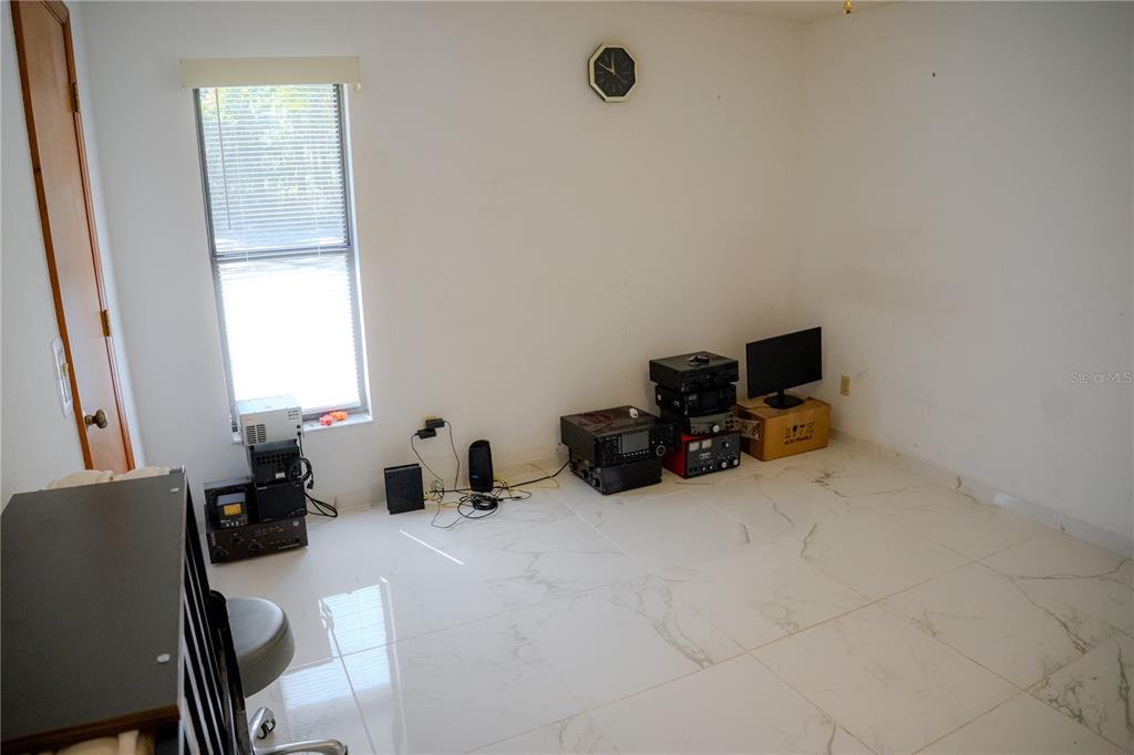 4150 South Apopka Avenue Inverness, FL 34452 - Photo 53 of 84 a room with a bed and a chair