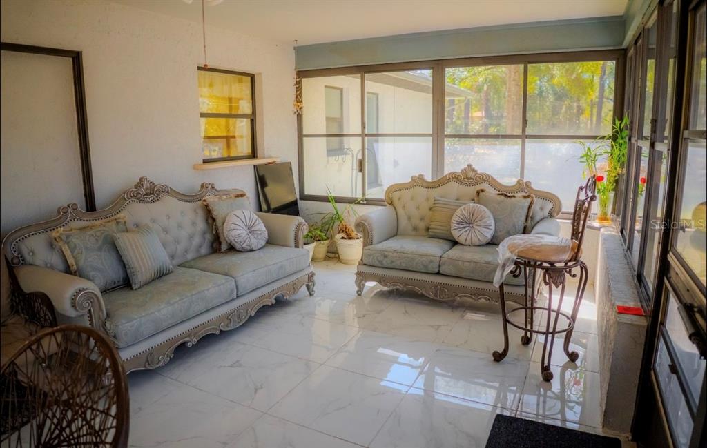 4150 South Apopka Avenue Inverness, FL 34452 - Photo 58 of 84 a living room with furniture and a floor to ceiling window