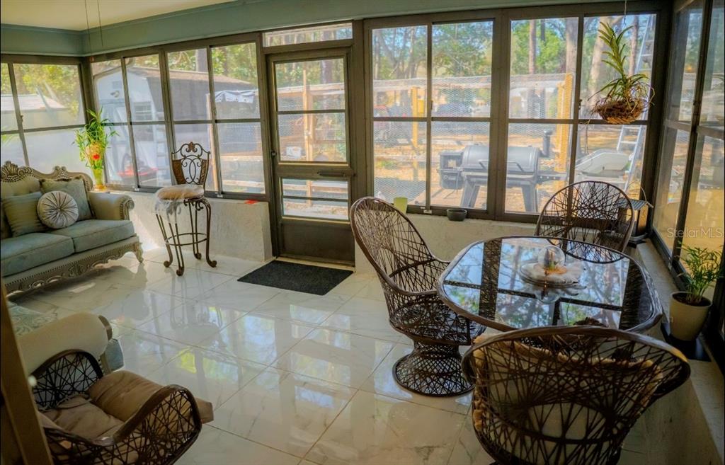 4150 South Apopka Avenue Inverness, FL 34452 - Photo 59 of 84 a living room with furniture and a floor to ceiling window