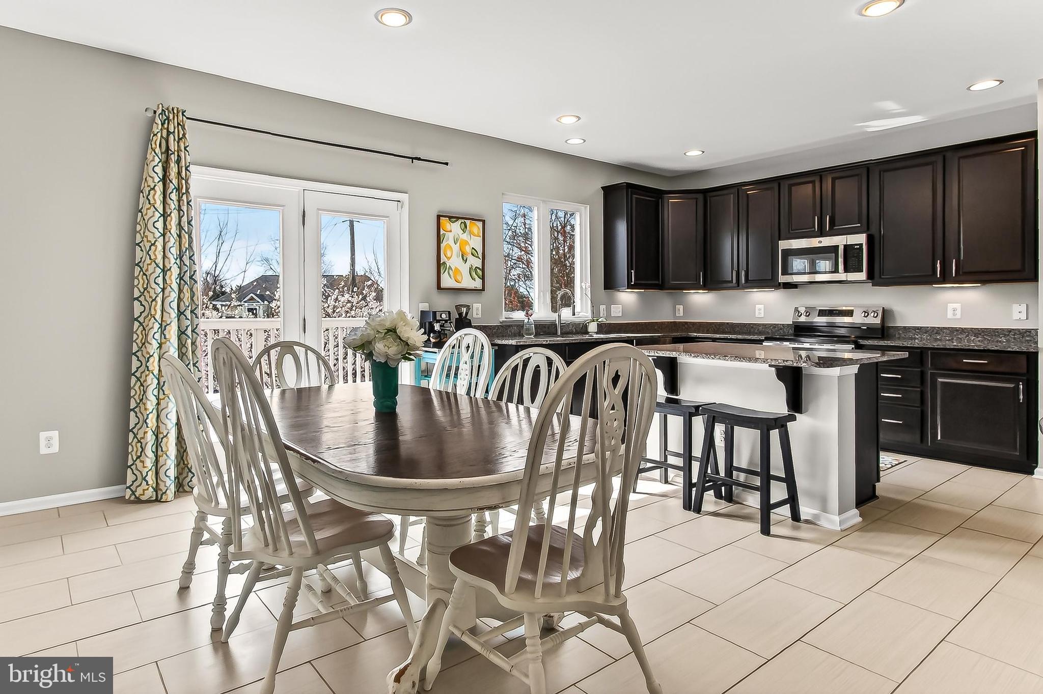 43473 Hopestone Terrace Chantilly, VA 20152 - Photo 23 of 49 a kitchen with stainless steel appliances granite countertop a table and chairs in it