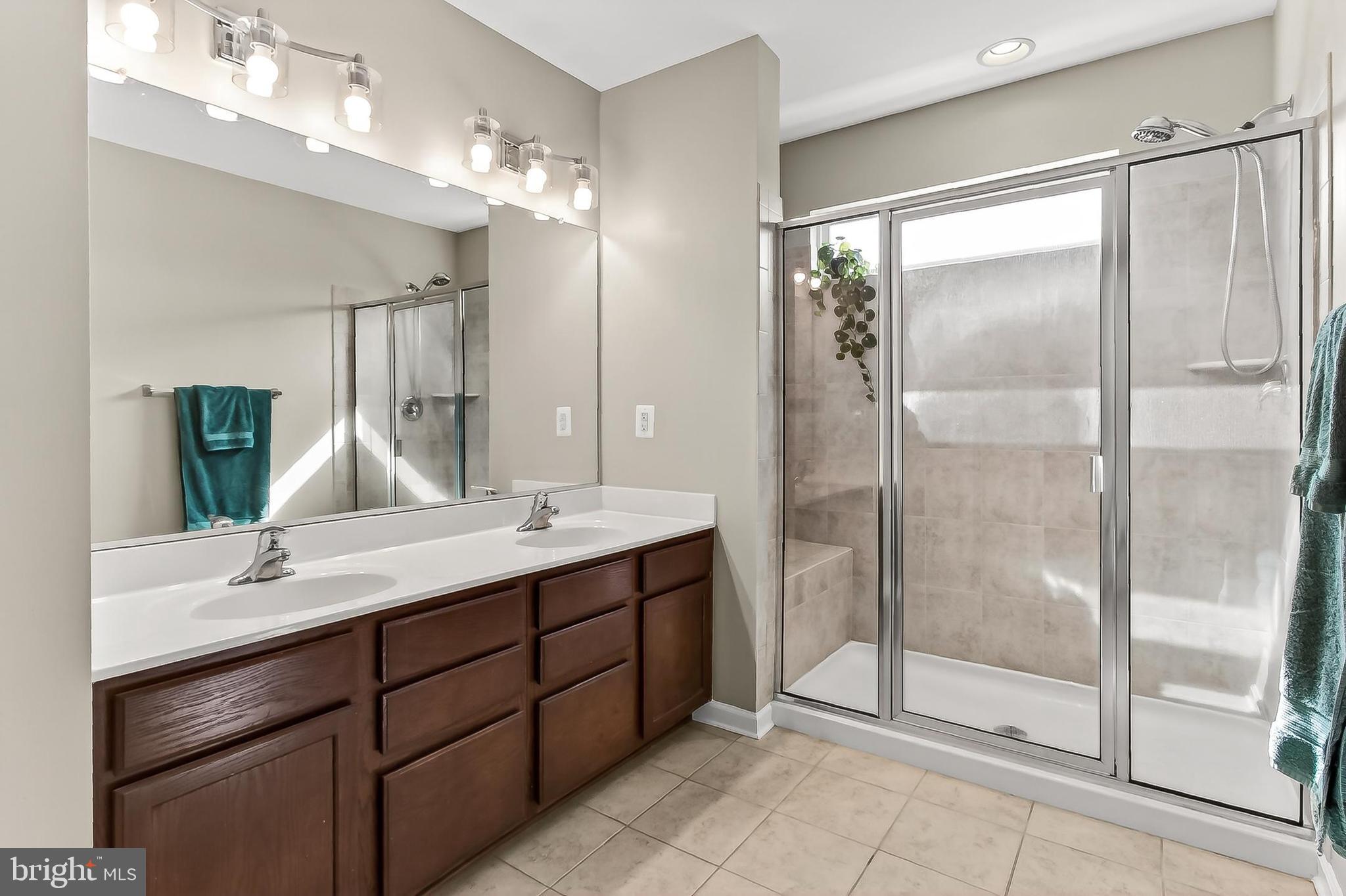 43473 Hopestone Terrace Chantilly, VA 20152 - Photo 29 of 49 a bathroom with a double vanity sink mirror and shower