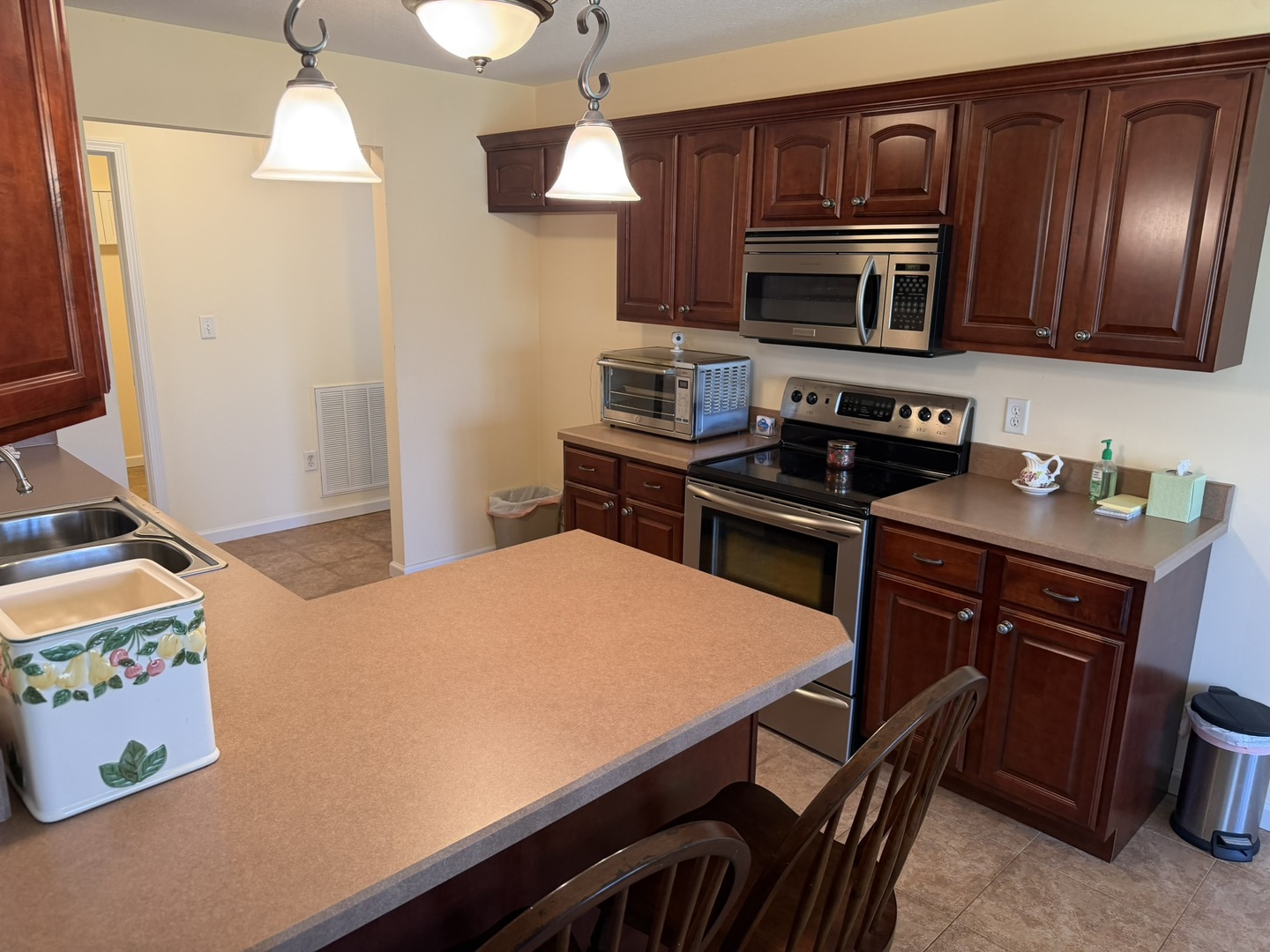 2 Dove Lane Metropolis, IL 62960 - Photo 13 of 35 a kitchen with stainless steel appliances a stove a microwave and cabinets
