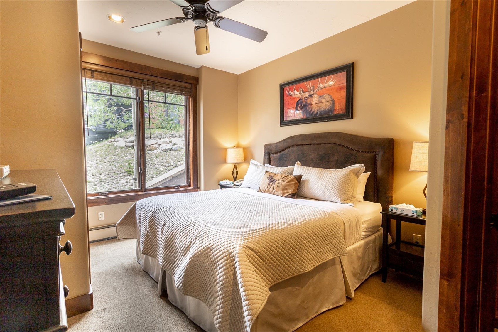 1891 Ski Hill Road, Unit 7000 Breckenridge, CO 80424 - Photo 13 of 25 a bedroom with a bed and a chandelier