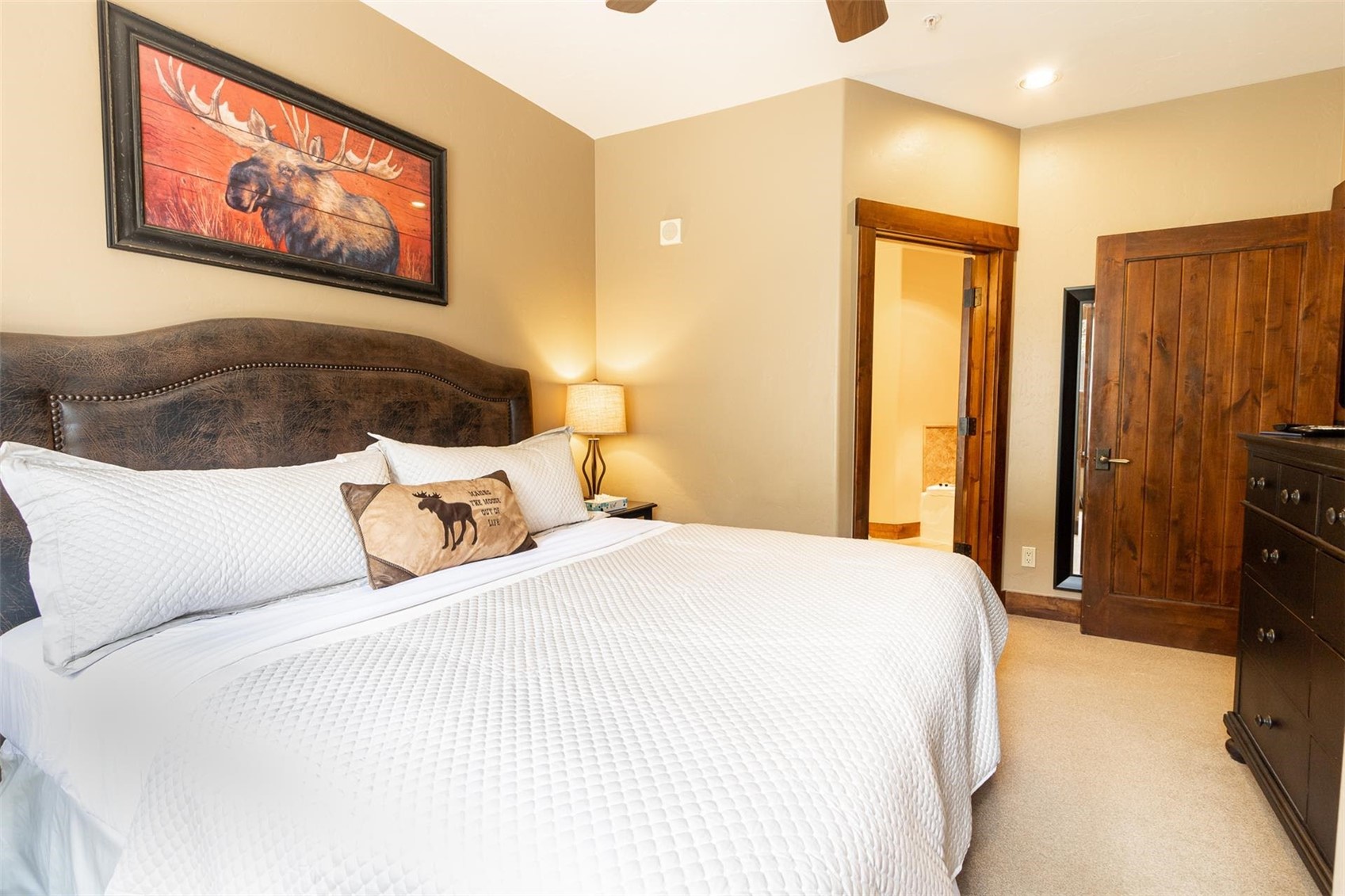 1891 Ski Hill Road, Unit 7000 Breckenridge, CO 80424 - Photo 14 of 25 a bedroom with a bed and a painting on the wall