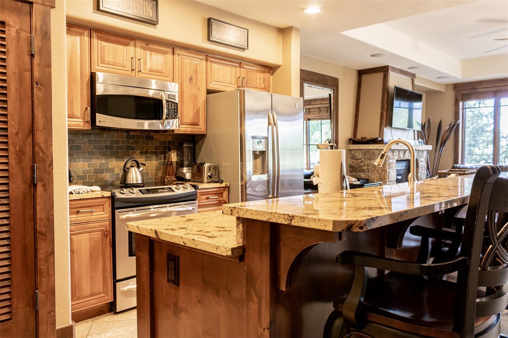 1891 Ski Hill Road, Unit 7000 Breckenridge, CO 80424 - Photo 5 of 25 a kitchen with stainless steel appliances granite countertop a sink and cabinets