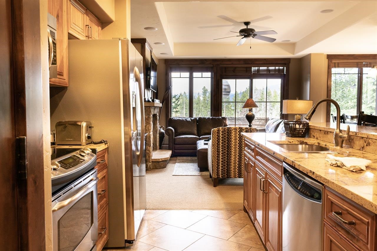 1891 Ski Hill Road, Unit 7000 Breckenridge, CO 80424 - Photo 6 of 25 a view of a kitchen with a sink and a refrigerator