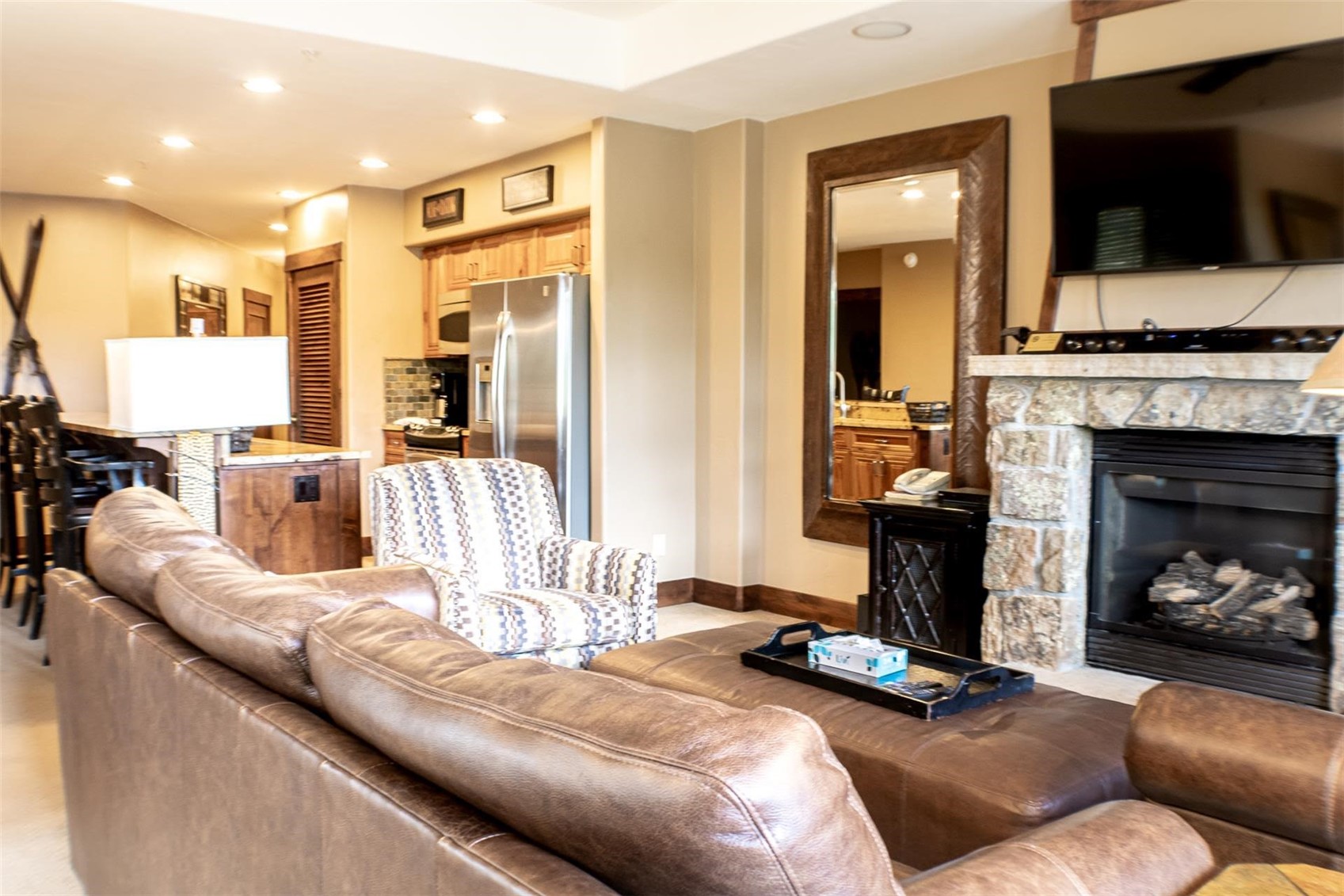 1891 Ski Hill Road, Unit 7000 Breckenridge, CO 80424 - Photo 7 of 25 a living room with furniture a flat screen tv and a fireplace