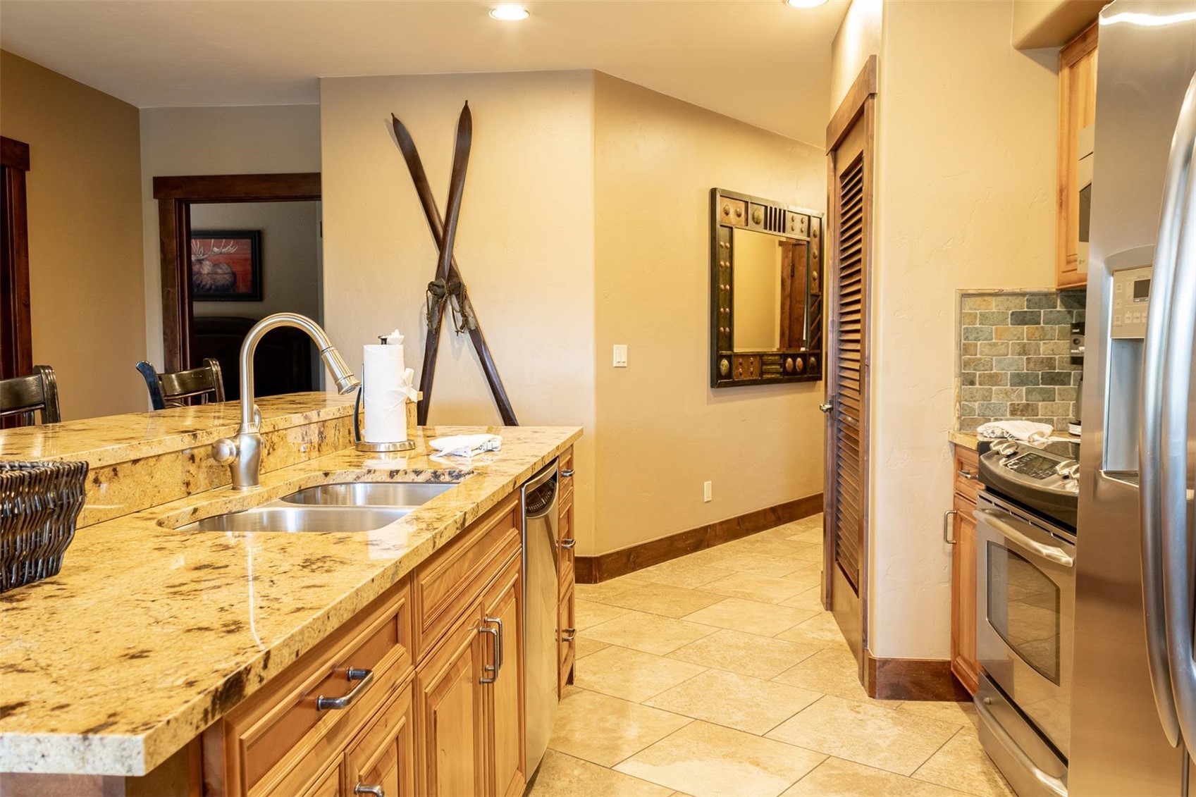 1891 Ski Hill Road, Unit 7000 Breckenridge, CO 80424 - Photo 9 of 25 a bathroom with a granite countertop sink and a mirror