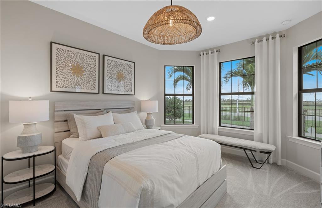 20498 Pebble Gln Drive Estero, FL 33928 - Photo 20 of 46 a spacious bedroom with a bed and a painting on the wall