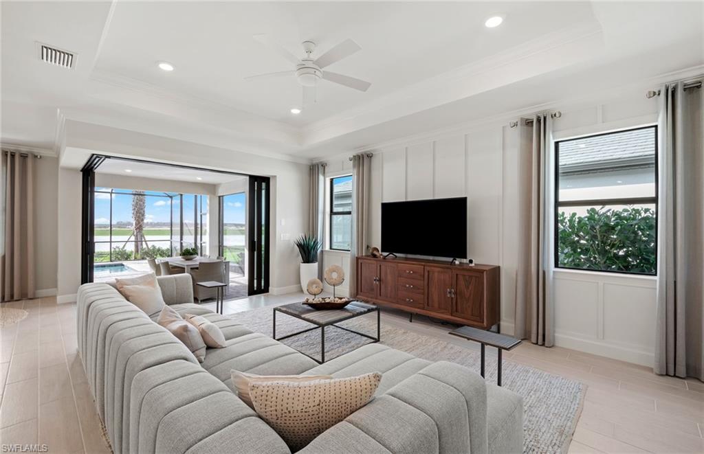 20498 Pebble Gln Drive Estero, FL 33928 - Photo 27 of 46 a living room with furniture and a flat screen tv