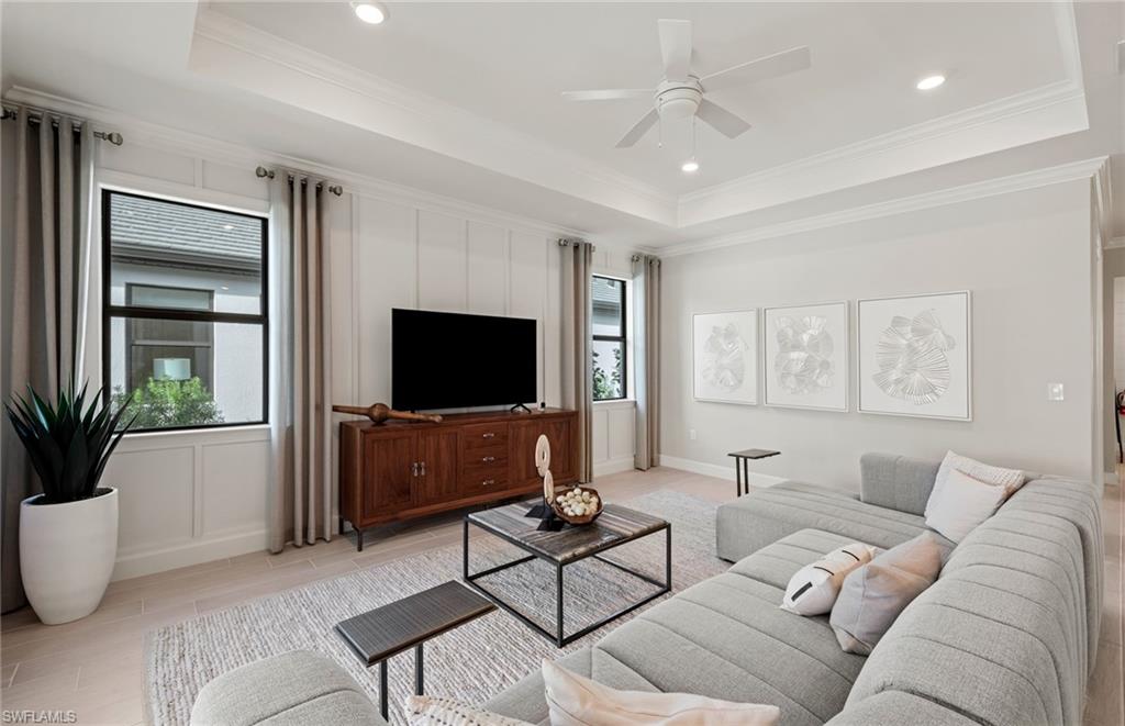 20498 Pebble Gln Drive Estero, FL 33928 - Photo 28 of 46 a living room with furniture and a flat screen tv
