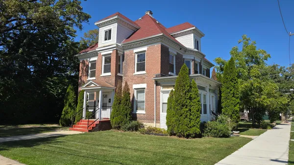 a front view of a house with a yard