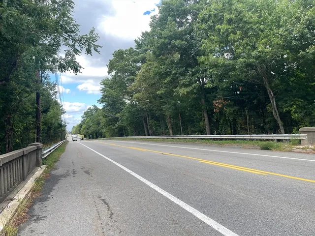 a view of a road with a trees in the background