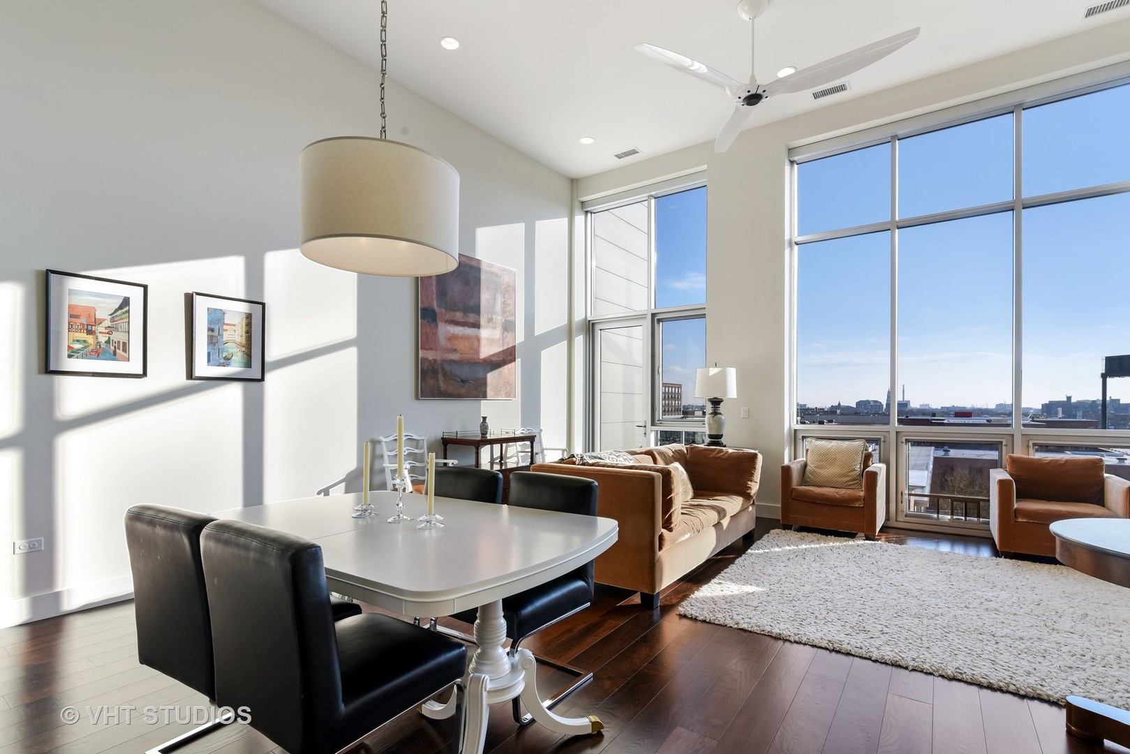 1132 West Adams Street, Unit PHE Chicago, IL 60607 - Photo 2 of 23 a dining room with furniture a window and a chandelier
