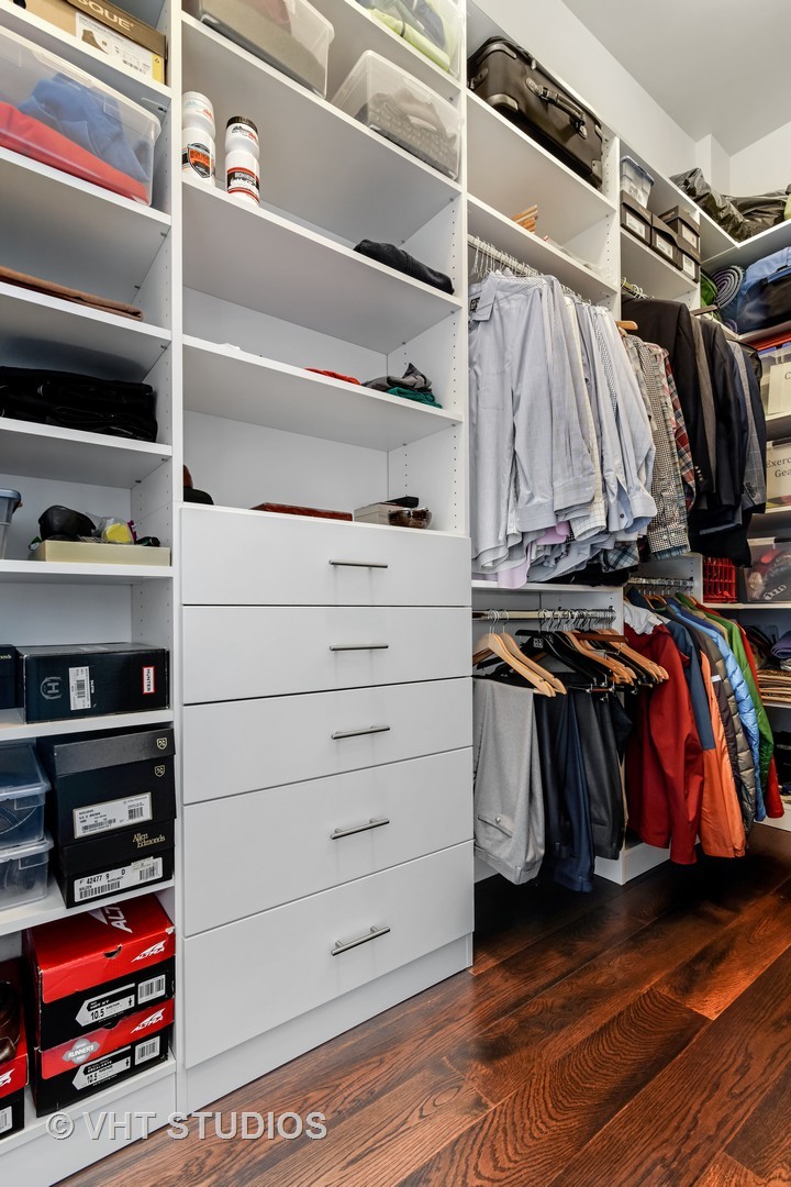 1132 West Adams Street, Unit PHE Chicago, IL 60607 - Photo 11 of 23 a view of walk in closet with clothes and shoes