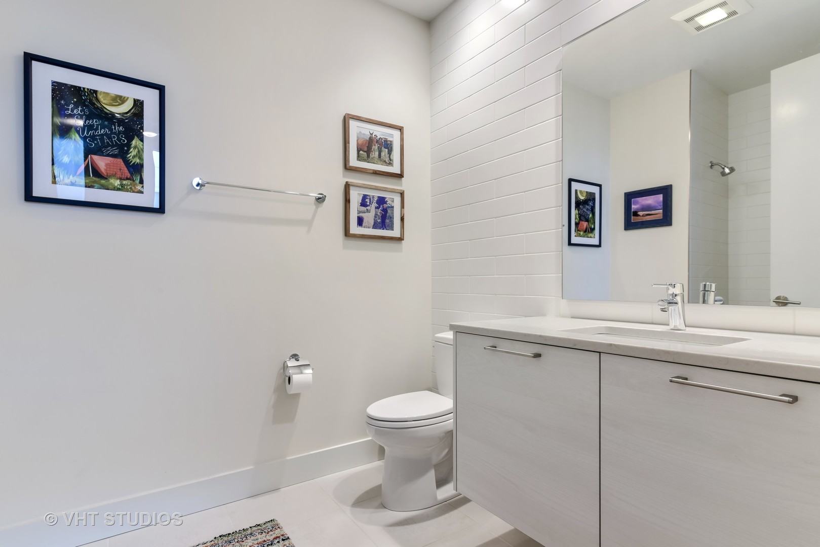 1132 West Adams Street, Unit PHE Chicago, IL 60607 - Photo 15 of 23 a bathroom with a toilet a sink and mirror