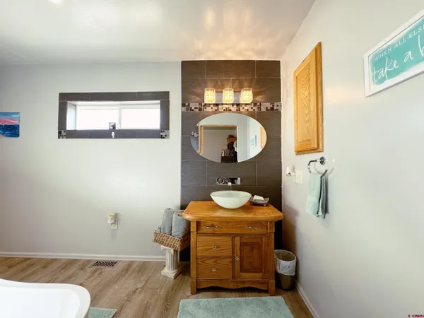 a bathroom with a sink mirror vanity and toilet