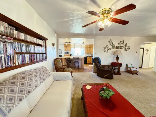 a living room with furniture fireplace and a large window