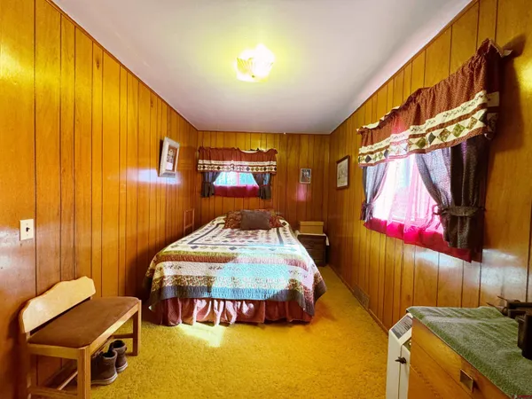 a bedroom with a bed and a couch