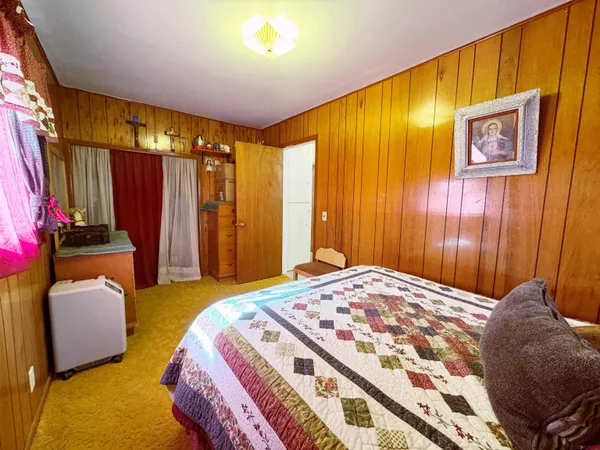a bedroom with a bed and flat screen tv