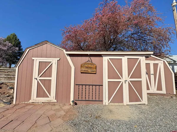 a backyard of a house with barbeque oven and outdoor seating