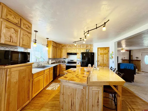 a kitchen with stainless steel appliances granite countertop a sink and cabinets