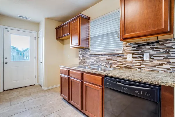 a kitchen with stainless steel appliances granite countertop a sink and a stove