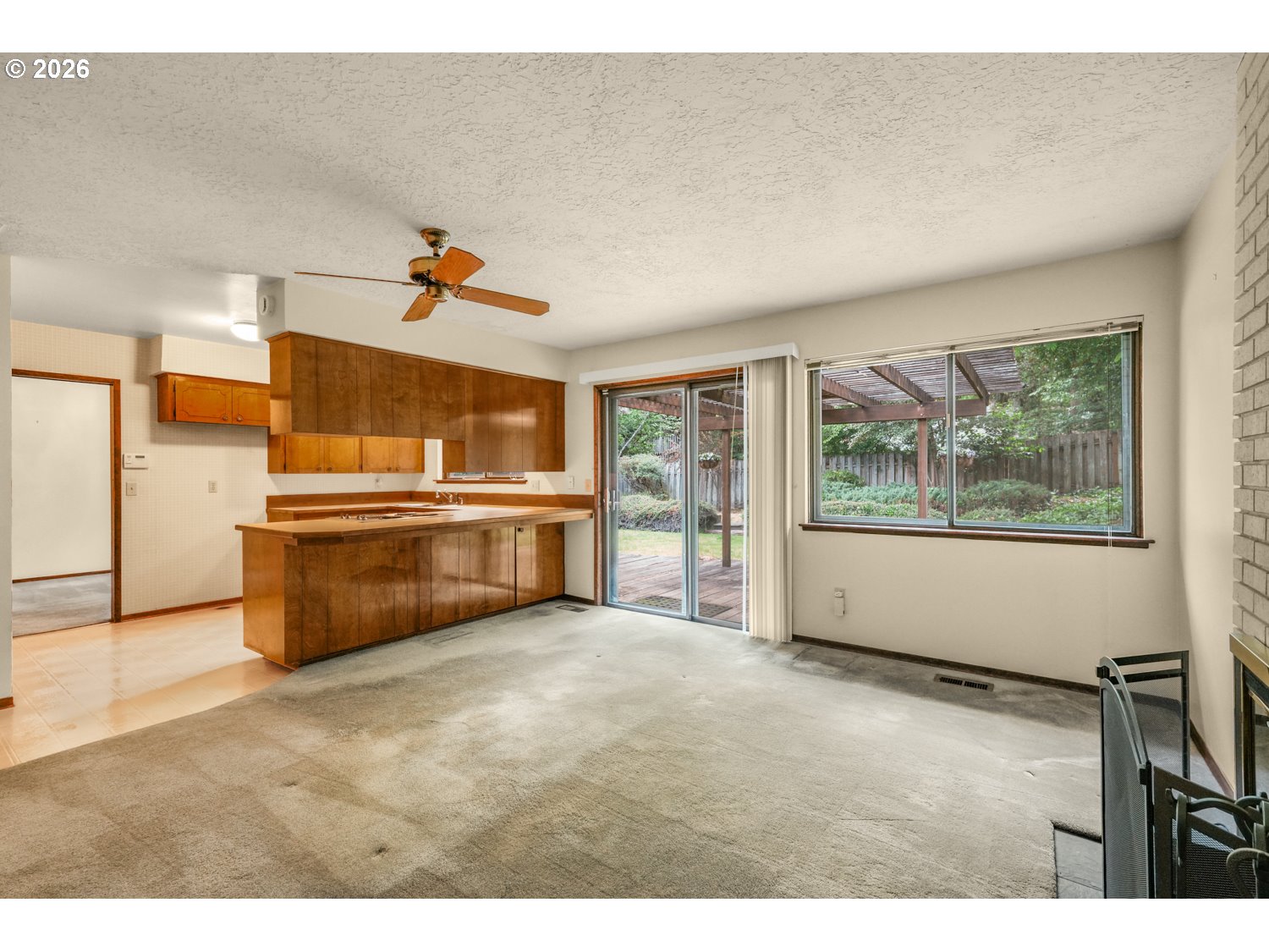 14155 Southwest 27th Street Beaverton, OR 97008 - Photo 15 of 27 a living room with stainless steel appliances kitchen island granite countertop furniture and a large window