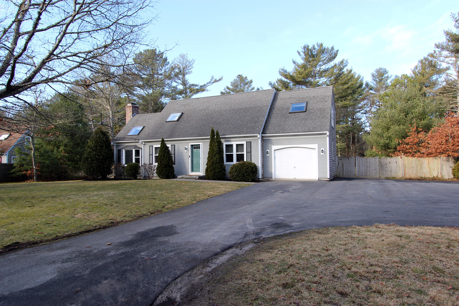 245 Simon Narrows Road Mashpee, MA 02649 - Photo 3 of 38 a front view of a house with a yard and garage