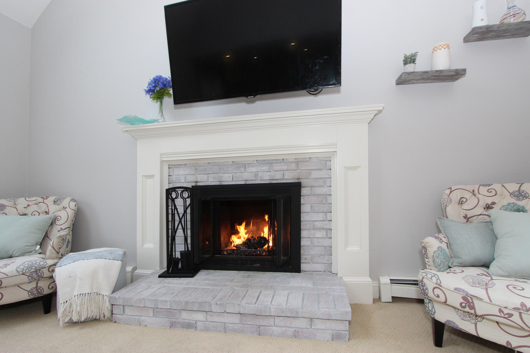 245 Simon Narrows Road Mashpee, MA 02649 - Photo 10 of 38 a living room with furniture and a fireplace