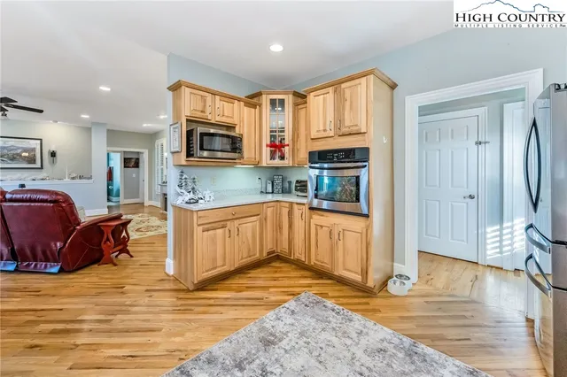 a kitchen with stainless steel appliances granite countertop a refrigerator stove top oven and sink
