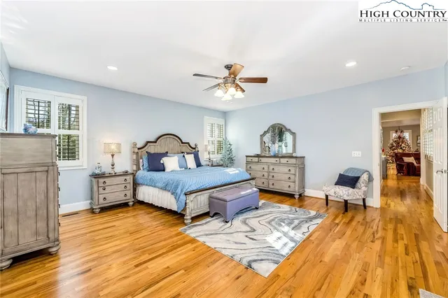 a bedroom with furniture and wooden floor