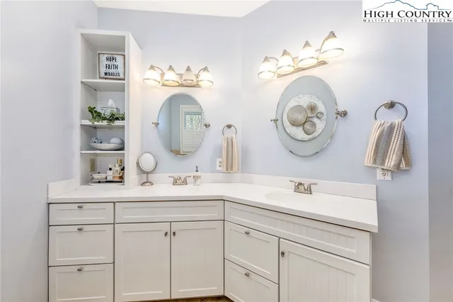 a bathroom with a double vanity sink and a mirror