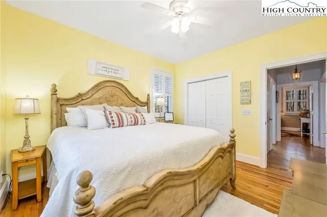 a bedroom with a bed and a chandelier