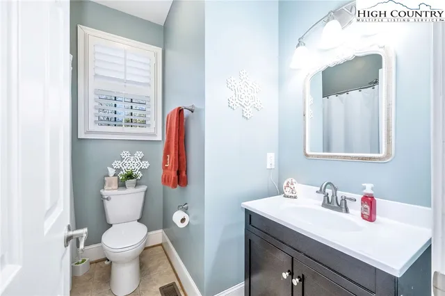a bathroom with a sink vanity mirror and toilet