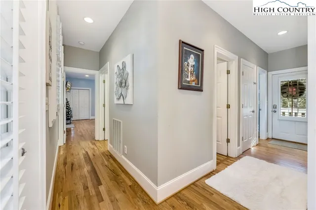 a view of a hallway view with wooden floor and staircase
