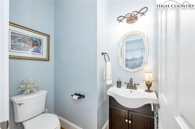 a bathroom with a sink mirror and toilet