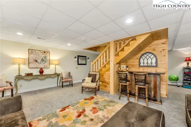 a living room with fireplace furniture and a wooden floor