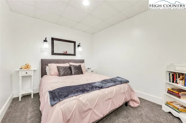 a bedroom with a bed and a wall painting