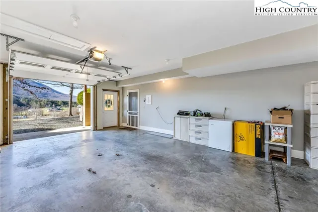 a dining room with wooden floor and a rug