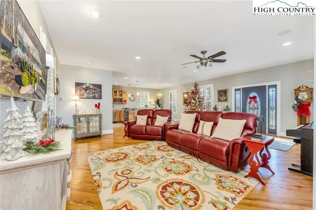 a living room with furniture and a chandelier