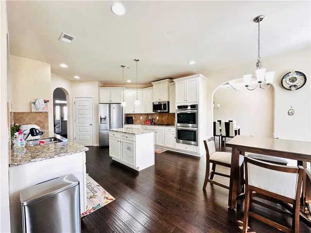a view of kitchen and dining area with furniture