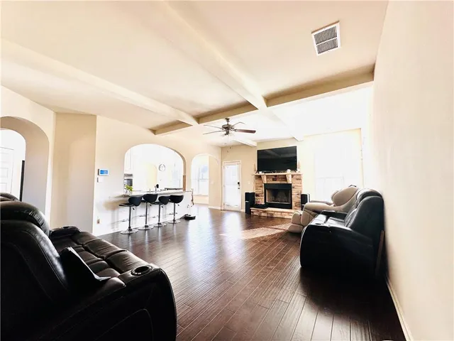 a living room with furniture and wooden floor