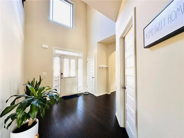 a view of a hallway with wooden floor and glass door
