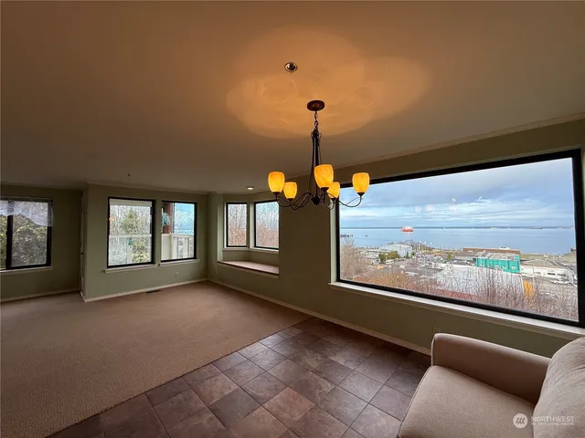 a view of a livingroom with a ceiling fan and window