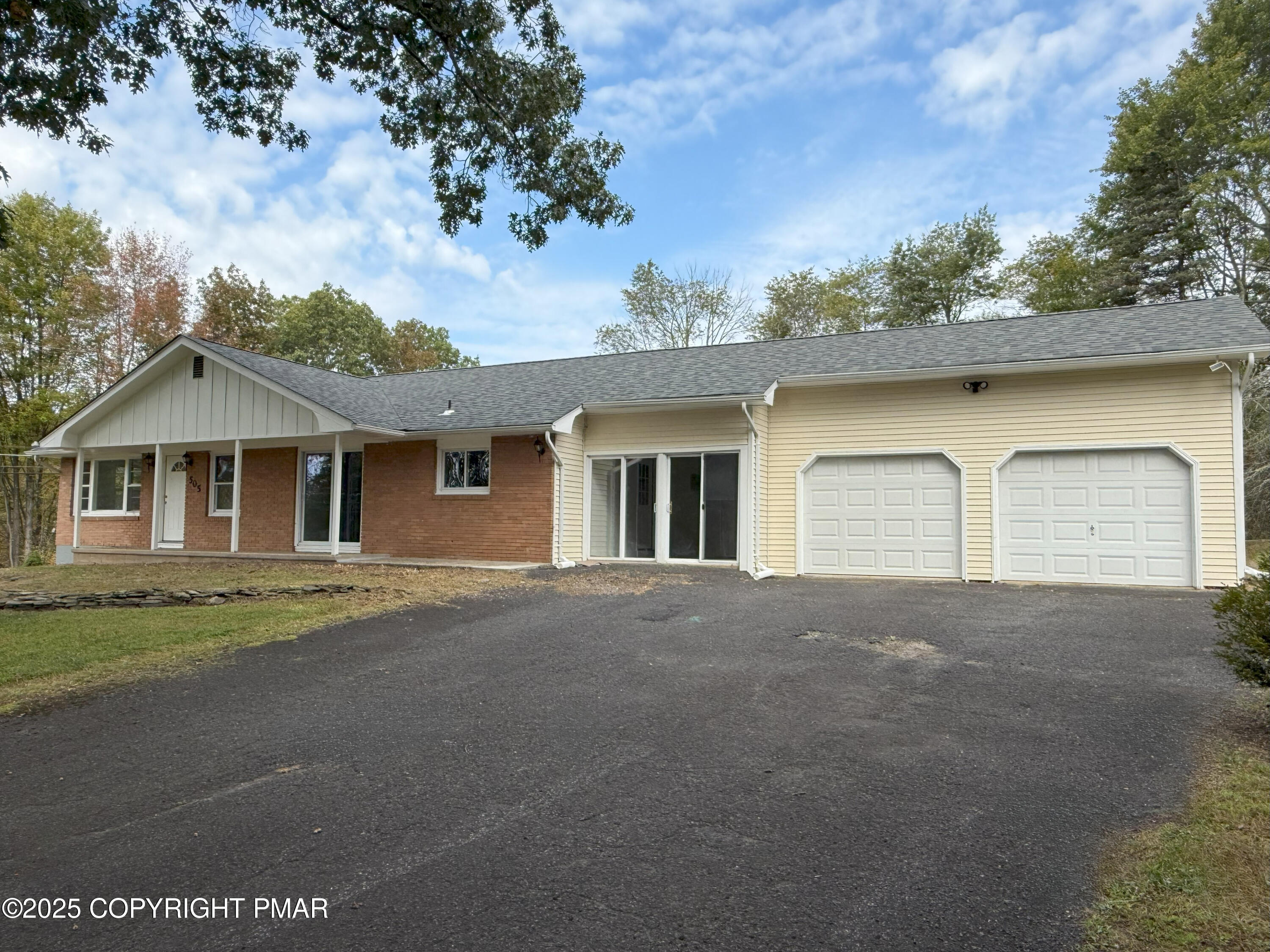 505 Stewart Court Bushkill, PA 18324 - Photo 1 of 34 a front view of a house with a yard and garage