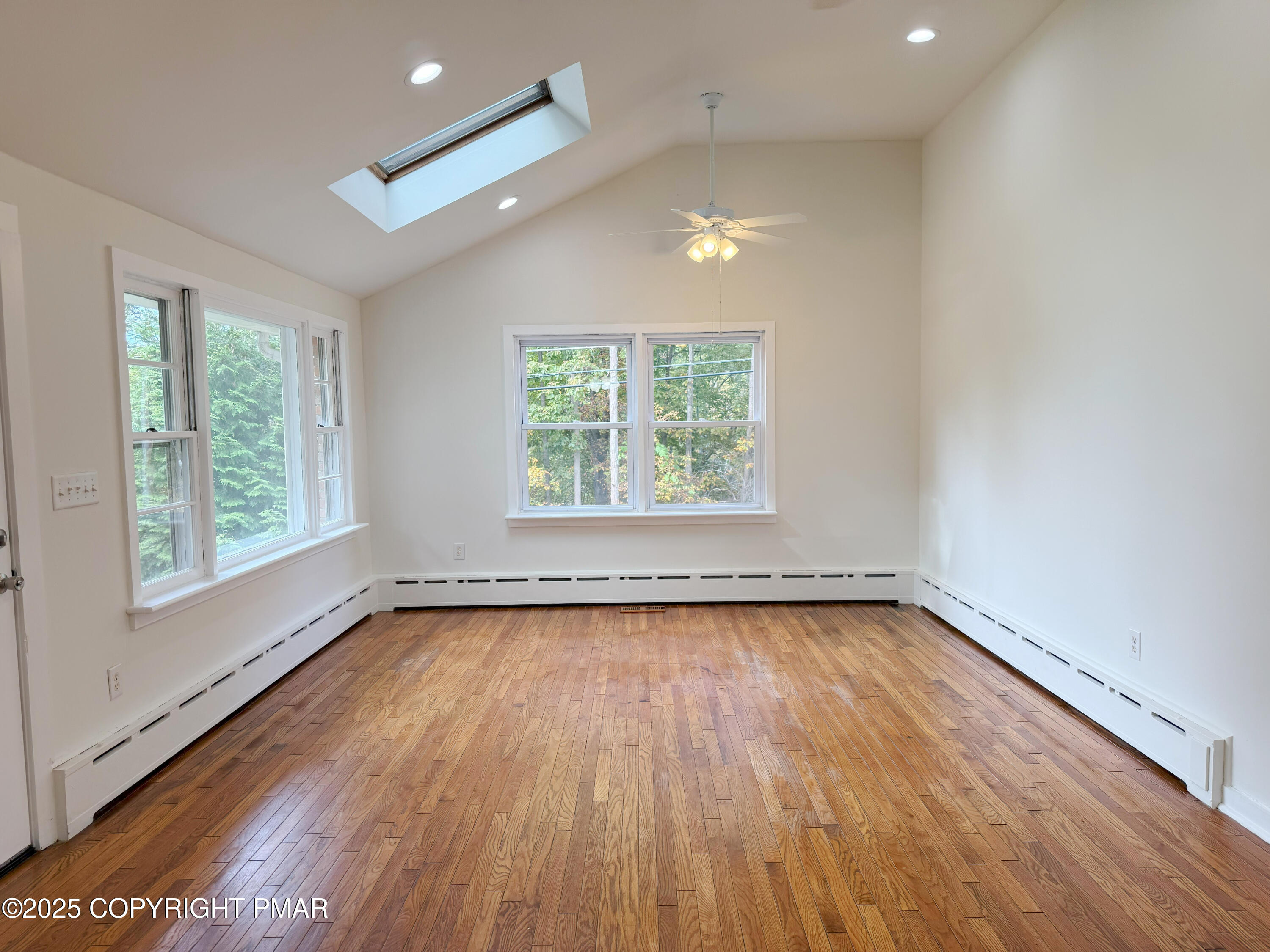 505 Stewart Court Bushkill, PA 18324 - Photo 11 of 34 an empty room with wooden floor and windows