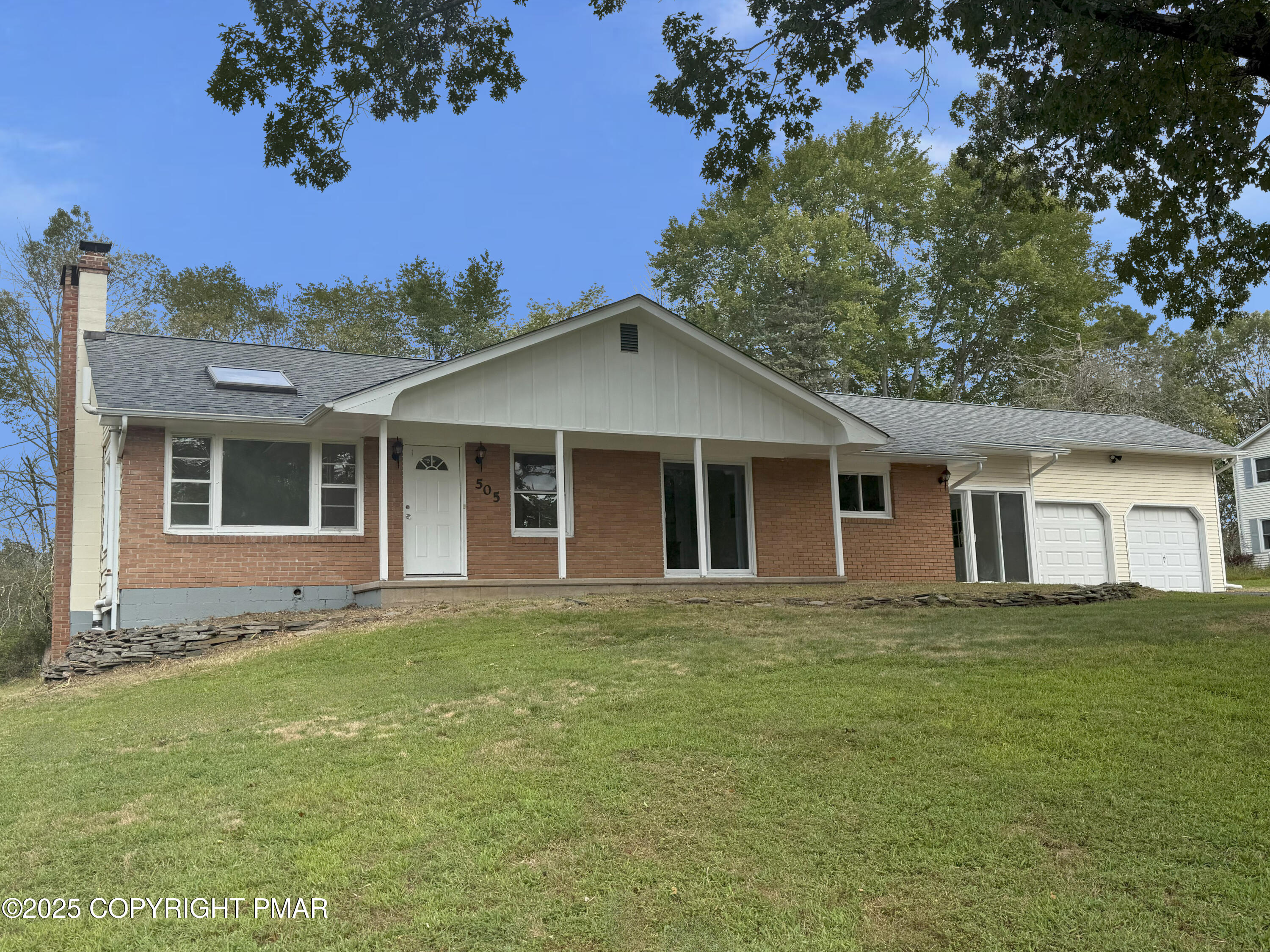 505 Stewart Court Bushkill, PA 18324 - Photo 2 of 34 a front view of a house with a garden