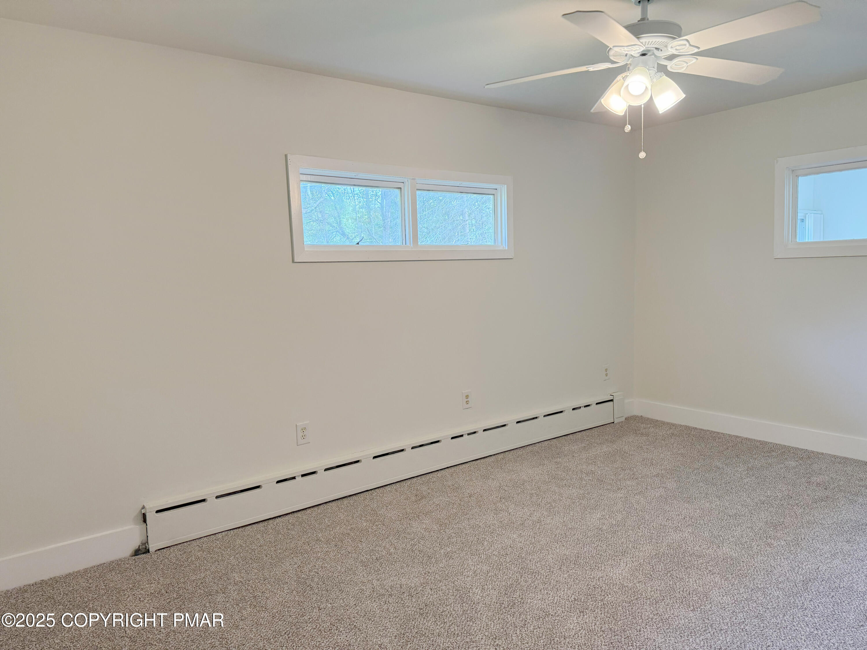 505 Stewart Court Bushkill, PA 18324 - Photo 26 of 34 an empty room with a ceiling fan and a window