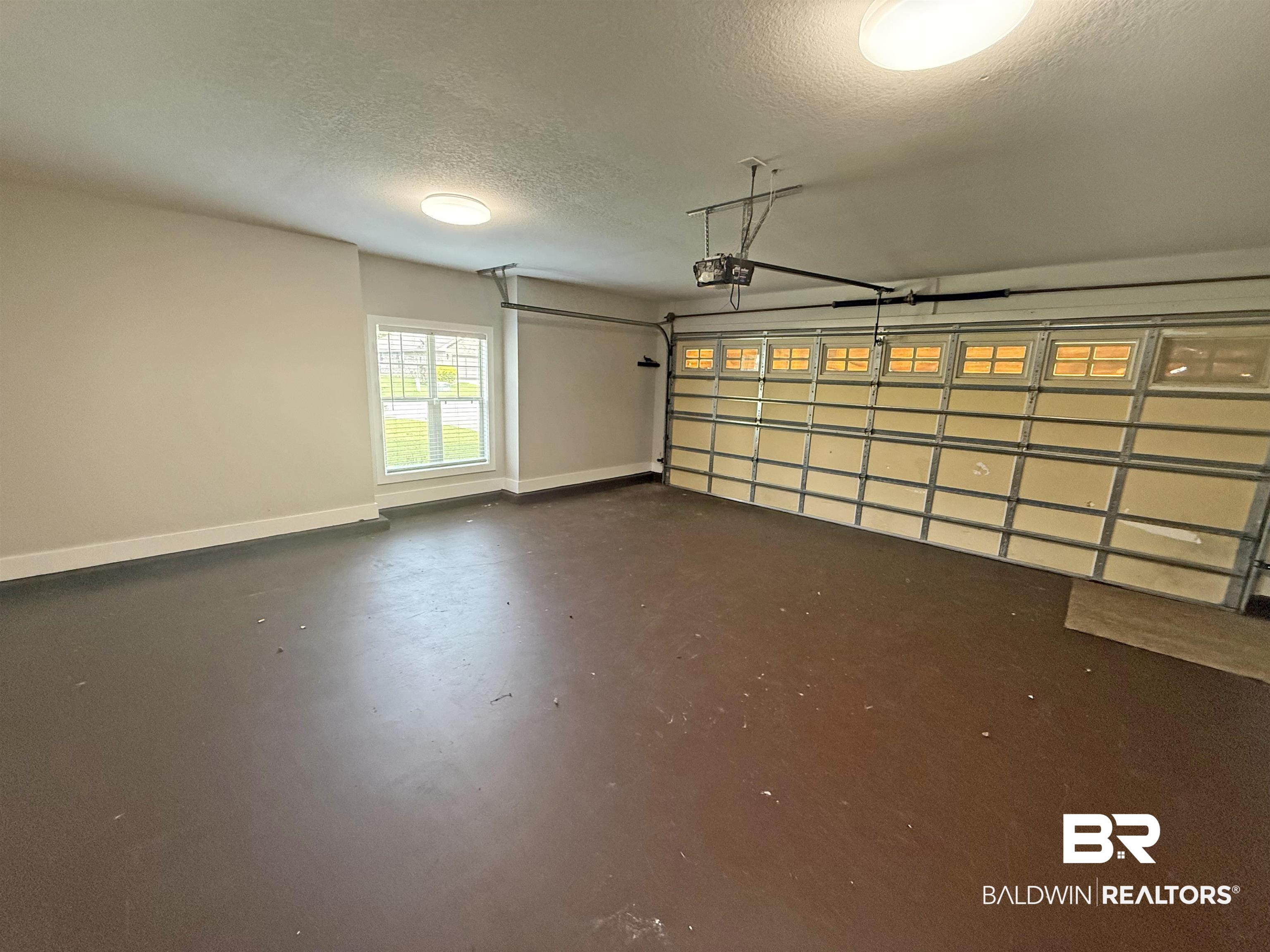 22023 Garland Loop Silverhill, AL 36576 - Photo 29 of 33 Garage with a garage door opener and baseboards